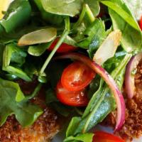 Veal Milanese Capricciosa · Breaded veal cutlet topped with a salad of tomato, red onions, oil, and balsamic vinegar.