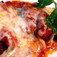 Veal Parmigiana · Breaded veal scalloppini topped with tomato sauce and mozzarella.