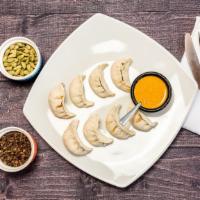 Steamed Momo · Your choice of vegetable, chicken or lamb. Steamed dumpling filled with vegetable, chicken o...