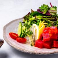 Ahi Tuna Poke Salad · Tuna cubes with organic spring mix, cucumber, edamame, onion, seaweed, along with rice.