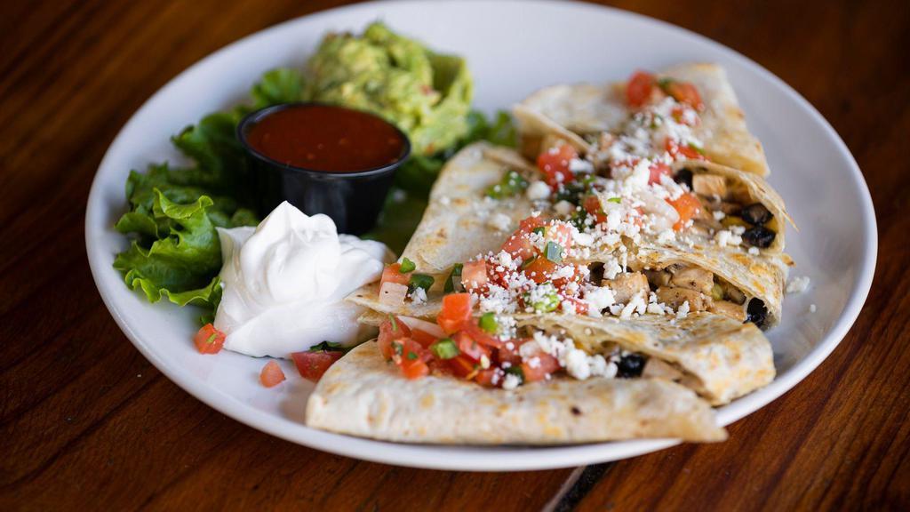Grilled Quesadilla · Choice of pulled pork, chicken or ground beef on flour tortilla with black beans, corn, monterrey jack cheese. Topped with pico de gallo, queso fresco, sour cream, guacamole, and salsa on the side.