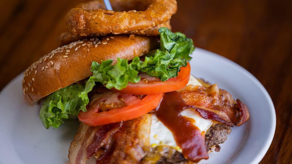 Hangover Burger · Beef patty burger with pulled pork, Tillamook sharp cheddar, & BBQ sauce.