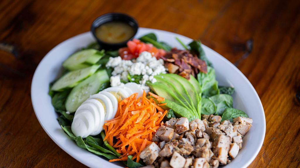 Cobb Salad · Smoked chicken, bacon, carrots, cucumbers, avocado, hard boiled egg, tomatoes & blue cheese crumbles.