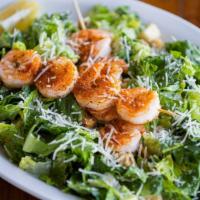 Blacked Shrimp Caesar Salad · Crispy romaine lettuce tossed in Caesar dressing with croutons & Parmesan cheese.