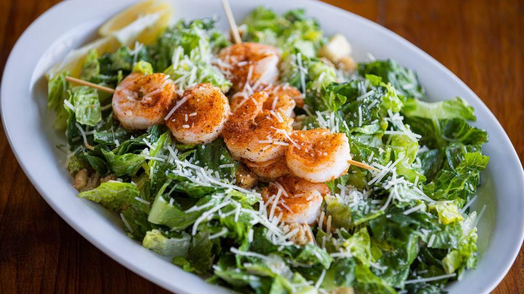 Blacked Shrimp Caesar Salad · Crispy romaine lettuce tossed in Caesar dressing with croutons & Parmesan cheese.