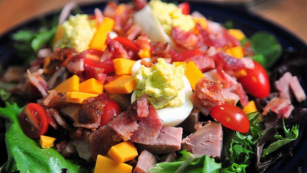 American Chopped Salad · Fresh greens topped with lean ham, smoked turkey, swiss & Tillamook sharp cheddar cheese, tomatoes, carrots, black olives, green onions & hard boiled egg.