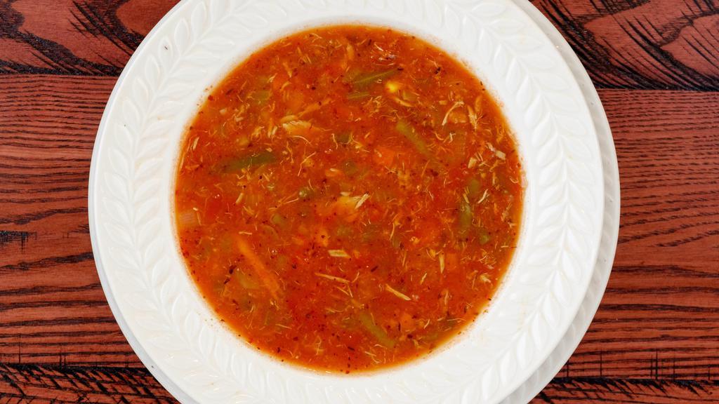 Bowl Maryland Crab Soup · Claw meat and vegetables in a tomato base