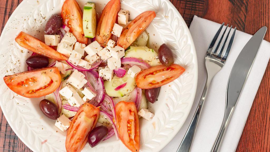 Horiatiki Salad · Grape tomatoes, cucumber, red onion, imported Greek Kalamata olives, feta cheese and Greek oregano tossed in a red wine vinaigrette.