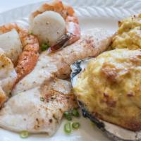 Broiled Seafood Platter · A stuffed oyster, a crab cake, fillet of fish, scallops and shrimp broiled in lemon butter. ...