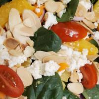 Ensalada De Espinacas · Spinach salad with oranges, almonds, red onions, carrots, tomato, goat cheese, and sherry dr...