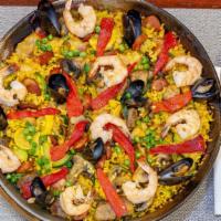 Paella Valenciana · Gluten free. Simmering saffron rice with squid and chicken. topped with shrimps, tilapia, gr...