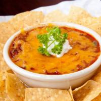 Shiner Bock Skillet Chili · Slow cooked, Texas style, no beans, topped with cheddar cheese and scoop of sour cream