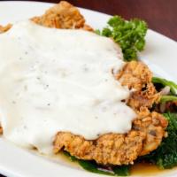 Chicken Fried Ribeye · A big crispy ribeye smothered in pepper gravy. Served with garlic Parmesan mashed potatoes a...