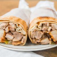 Chicken Shawarma · Slow roasted and shaved dark chicken meat with garlic sauce and pickles.