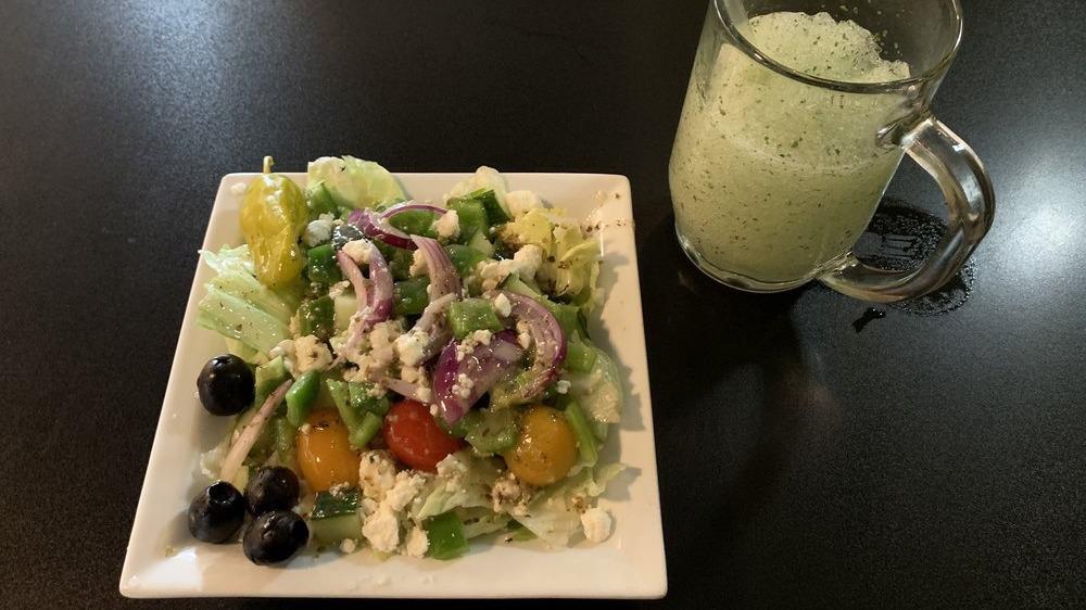 Greek Salad · A mixture of fresh iceberg amd romaine lettuce, tomatoes, cucumbers, bell peppers and onions. Topped with chunks of feta cheese, black olives and special olive oil dressing.