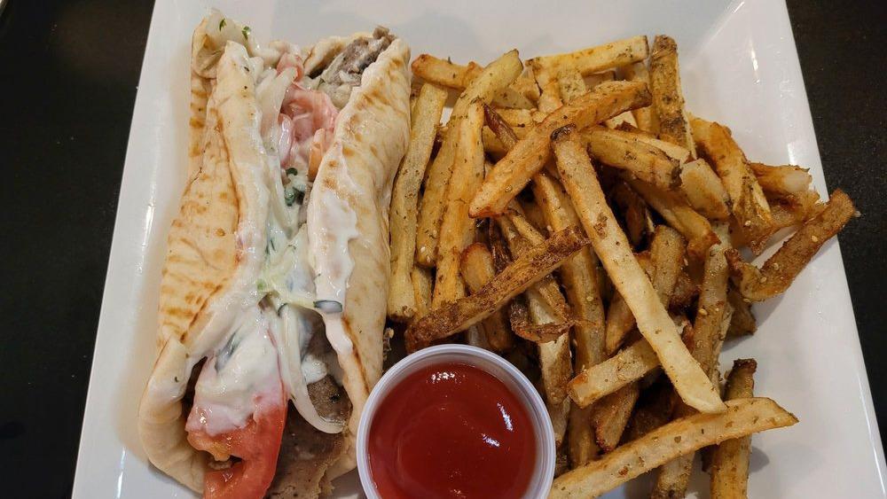 Gyro Sandwich · A generous amount of seasoned gyro meat rolled in pita bread with tangy yogurt sauce, tomatoes and onions.