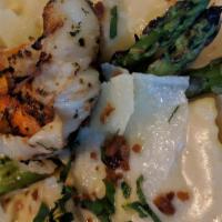 Lobster Ravioli · Grilled lobster tail, sherried lobster cream, light truffle oil, parmesan shavings, asparagu...