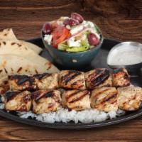 Souvlaki · Medallions of chicken tenderloin, peppers, and onions on a skewer, pita bread and tzatziki s...