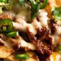 Nachos · Fresh crispy nachos topped with melted cheese, lettuce, tomato, sour cream and jalapeños. Ad...