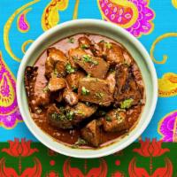 Lamb Curry · Lamb cooked with herbs and spices in a curry sauce. comes with rice.