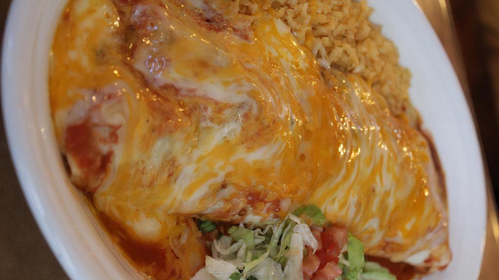 Burrito Dinner · 10” Burrito stuffed with beans, protein, topped with sauce, shredded cheese served with rice and beans.