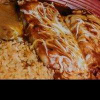 Tamales Dinner · Two tamales topped with your choice of sauce, melted shreded cheese, served with rice and be...