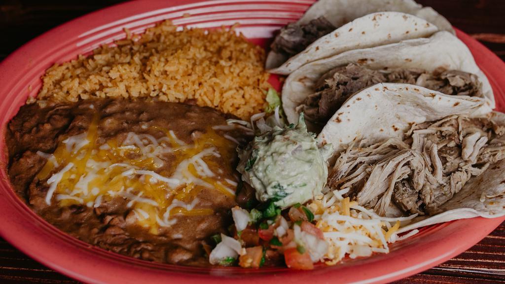 Taco Carnitas Dinner · Three soft flour carnitas tacos topped with shredded cheese, pico, lettuce,  served with rice and beans