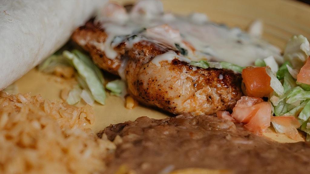 El Patron Chicken · Chicken breast topped with cheese dip served with tortillas, rice and beans