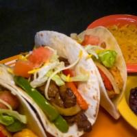 Soft Fajita Taco Dinner  · Three fajita soft flour tacos with your choice of protein, stuffed with red, green grilled p...