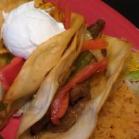 Puffy Fajita Dinner · Two deep-fried flour tacos stuffed with your choice of protein, red, green grilled peppers, ...