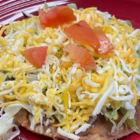  Tostada  · Bean tostada topped with lettuce, cheese, tomato
