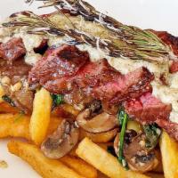Steak Frites · 8oz New York steak, wild mushroom, spinach, and a creamy peppercorn sauce with fries.