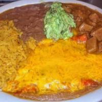 #17. Texas Plate · 2 cheese enchiladas toped w/mexican gravy sauce & melted cheese served w/carne guisada, rice...