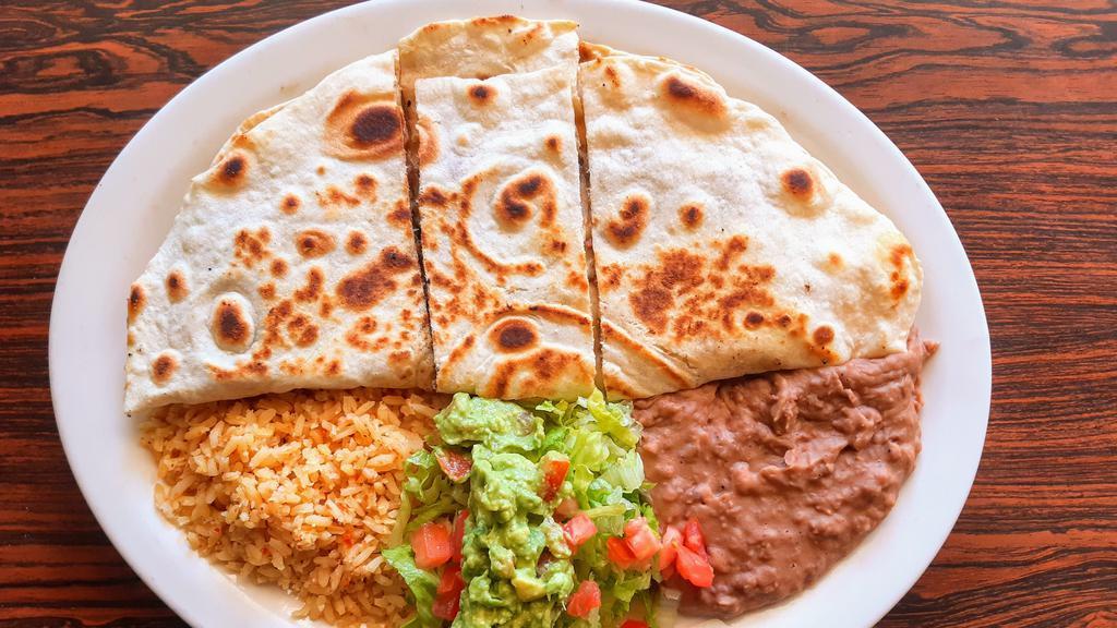 #24.Quesadilla Plate · A giant flour tortilla filled w/melted Monterrey cheese   & your choice of meat  served w/rice, beans & guacamole salad