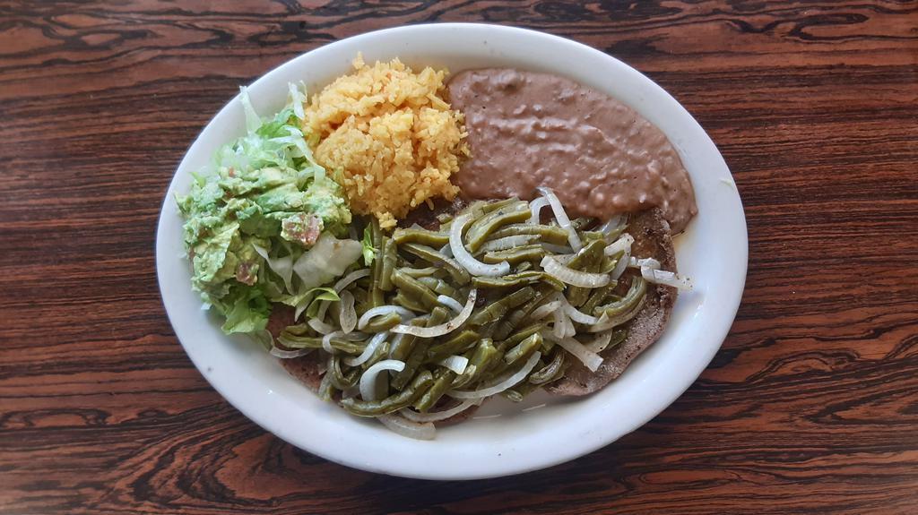 #1. Carne Asada Steak With Nopales · Steak toped w/grill wild cactus and onions served w/rice, beans, guacamole salad & 2 tortillas
