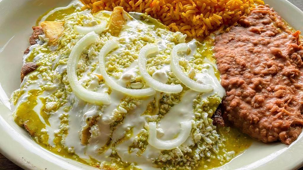 #13. Enchiladas Mayito · A steak toped w/ 3 green enchiladas dreseed w/ our special home style sauce, queso fresco & onions served w/ rice, beans, sour cream & 2 tortillas