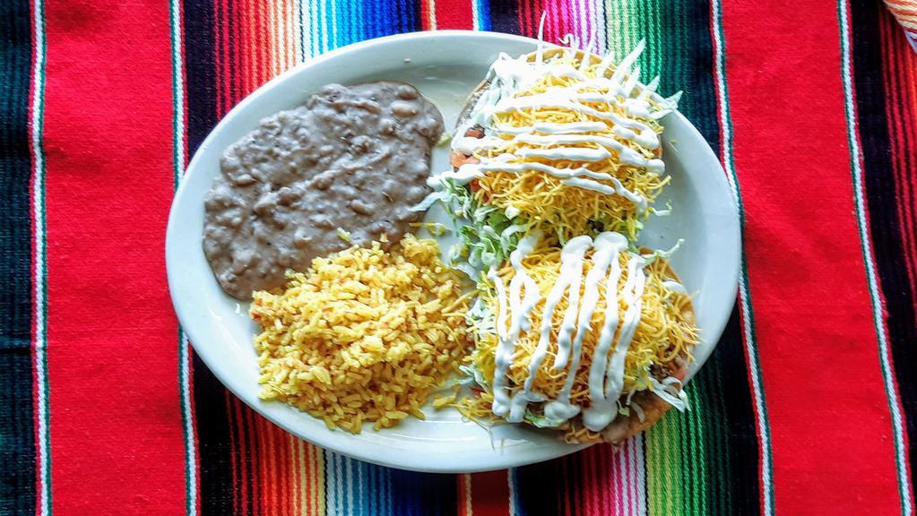  Chalupas Plate · 2 chalupas toped w/beans,your choice of meat, lettuce, tomatoes,cheese & sour cream served w/ rice& beans