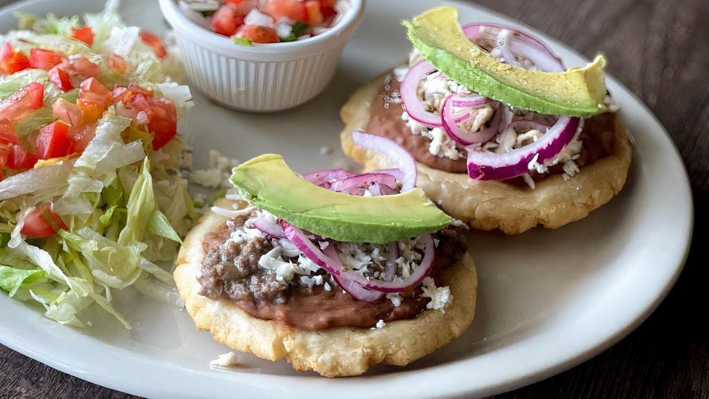 #25.Sopes Plate · 2 Sopes With Beans Beef or Chicken, Queso Fresco, Avocado & Onions Accompanied With Rice and Beans