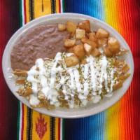 Green Chilaquiles Plate · fried corn strips dressed with house recipe green sauce, onion, queso fresco, sour cream,ser...