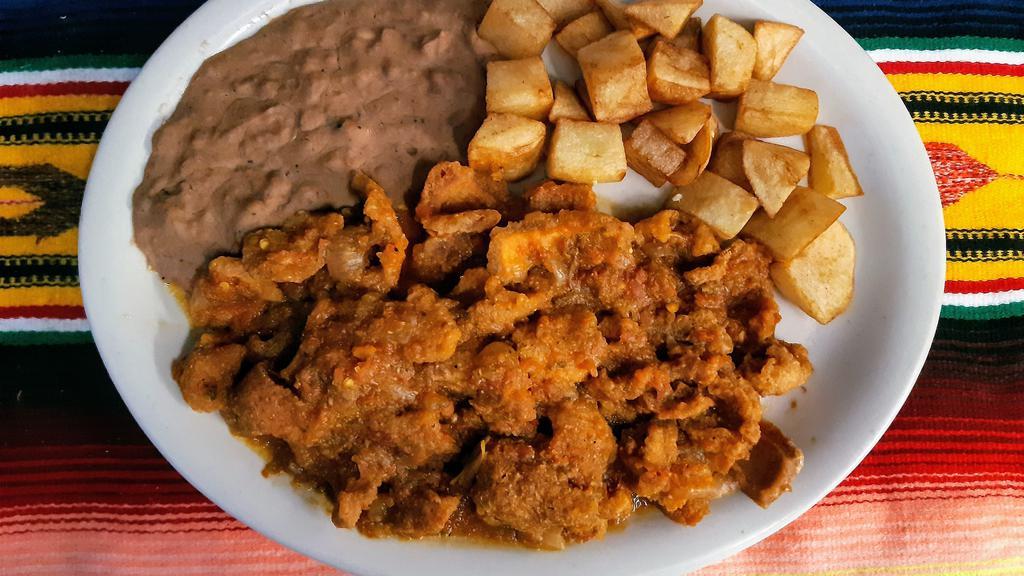 Chicharron Ranchero Plate · Chicharron (Pork skin) with ranchero sauce, served with beans, potatoes & 2 tortillas
