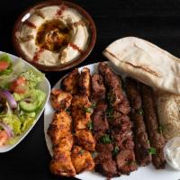 Kebab Family Meal · Two beef. Two chicken & two lule kebab skewers. Served with rice, hummus, house salad, two g...