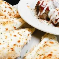 Meatballs & Cheese Bread · 4 of our amazing meatballs covered with sauce and baked mozzarella served with a 1/2 order o...
