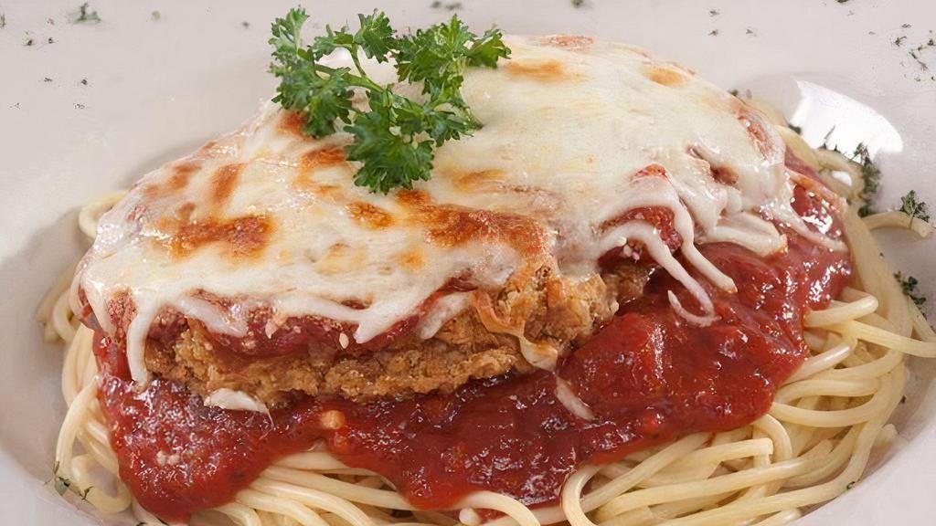 Chicken Parm Pasta · A grilled or breaded chicken breast topped with marinara sauce, Parmesan and mozzarella cheeses served with your choice of spaghetti marinara or fettuccine Alfredo, a side salad, and garlic roll.