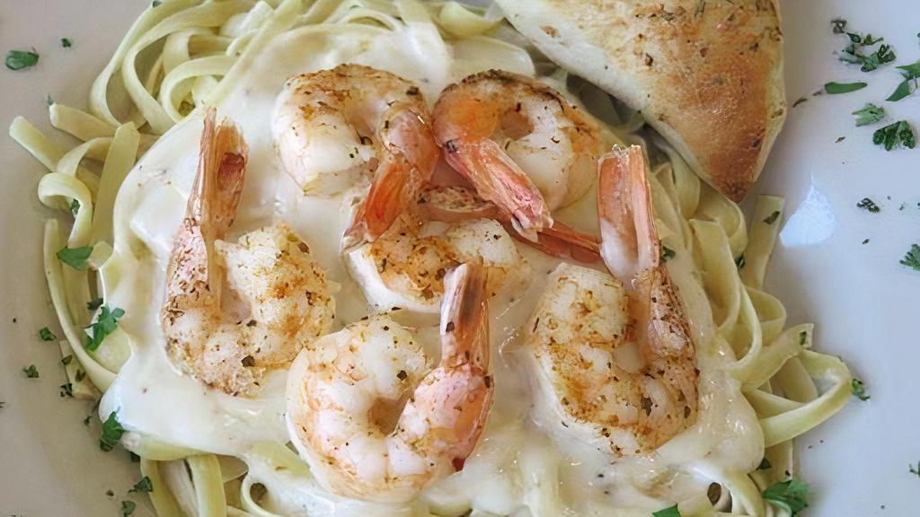 Shrimp Alfredo · Delicious shrimp blended with Alfredo sauce over fettuccine.  Served with a side salad, and garlic roll.