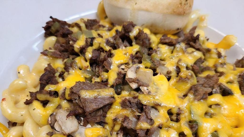 Philly Mac · Our homemade, rich & creamy cheese. sauce with Cavatappi pasta topped with chopped steak,. mushrooms, green peppers and onions.  Served with a side salad, and garlic roll.
