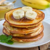 Banana Pancakes Platter · Delicious pancakes with delightful bananas. Comes with your choice of meat, eggs and cheese.
