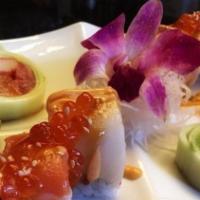 Hokkaido Roll · Spicy tuna, crab meat and cucumber inside, topped fresh salmon and white tuna, glazed with s...