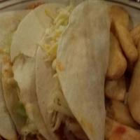 3 Mexican Street Tacos Served With Rice And Refried Beans · 3 tacos on corn tortillas  with cilantro and onion as garnish with your choice of protein se...