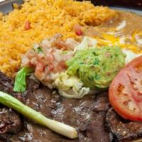 Cecina Con Nopales/Jerky Beef Meat W. Cactus  · served w/ yellow rice, pinto beans, cactus, tortillas, and salad.

Green and red sauce is se...