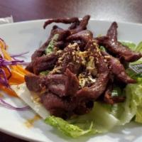 Beef Jerky · Deep fried sliced beef marinated with Thai sauce, Thai chili lime sauce.
